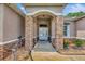 Inviting front entrance featuring stone accents, double doors, and manicured landscaping at 10305 Worthy Lamb Way, New Port Richey, FL 34654