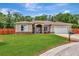 Charming single story home with a lush green lawn and an attached two car garage at 10305 Worthy Lamb Way, New Port Richey, FL 34654