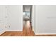 Hallway that features hardwood floors and neutral-colored walls, leading to additional rooms at 10305 Worthy Lamb Way, New Port Richey, FL 34654