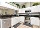Well-lit kitchen featuring stainless steel appliances and sleek countertops at 10305 Worthy Lamb Way, New Port Richey, FL 34654