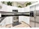 Well-lit kitchen featuring stainless steel appliances and sleek countertops at 10305 Worthy Lamb Way, New Port Richey, FL 34654