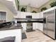 Well-lit kitchen featuring stainless steel appliances and sleek countertops at 10305 Worthy Lamb Way, New Port Richey, FL 34654