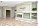Spacious living room with wood-look floors, fireplace feature and custom built-ins at 10305 Worthy Lamb Way, New Port Richey, FL 34654