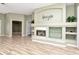 Inviting living room boasting wood floors, a fireplace, and plenty of space for relaxing and entertaining at 10305 Worthy Lamb Way, New Port Richey, FL 34654