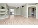Open living room with hardwood floors, fireplace, and sliding glass doors leading to the patio at 10305 Worthy Lamb Way, New Port Richey, FL 34654