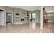 Expansive living room featuring wood floors, a fireplace, and seamless flow to the rest of the home at 10305 Worthy Lamb Way, New Port Richey, FL 34654
