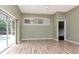 Living room with sliding glass door to pool at 10305 Worthy Lamb Way, New Port Richey, FL 34654
