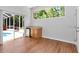 A living room with sliding glass doors to a pool with a wet bar area at 10305 Worthy Lamb Way, New Port Richey, FL 34654