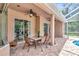 Covered outdoor patio area perfect for dining with ceiling fan and view of a pool at 10305 Worthy Lamb Way, New Port Richey, FL 34654