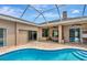 The screened pool is adjacent to the rear living area with sliding glass doors at 10305 Worthy Lamb Way, New Port Richey, FL 34654