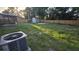 Spacious backyard featuring a new wooden fence, storage shed, screen house, and an AC unit at 11259 Elgin Blvd, Spring Hill, FL 34608