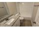Clean bathroom featuring a tub and granite vanity at 11259 Elgin Blvd, Spring Hill, FL 34608