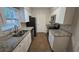Modern kitchen featuring granite countertops, stainless steel appliances, and white cabinetry at 11259 Elgin Blvd, Spring Hill, FL 34608