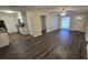 Bright, open-concept living area seamlessly connects to the kitchen, featuring modern floors and ample natural light at 11259 Elgin Blvd, Spring Hill, FL 34608