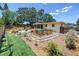 Well-maintained backyard with manicured lawn, a screened-in porch, and flourishing garden beds at 11376 119Th Ter, Largo, FL 33778