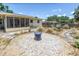 Backyard features xeriscaping, a garden, a fire pit, and a screened-in porch, creating a private and inviting outdoor oasis at 11376 119Th Ter, Largo, FL 33778
