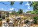 Landscaped backyard with mature trees, fire pit, fenced yard, and inviting seating area, perfect for outdoor entertaining at 11376 119Th Ter, Largo, FL 33778