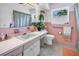 Vintage pink bathroom with classic tile, large mirror, and ample counter space at 11376 119Th Ter, Largo, FL 33778