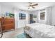 Bright bedroom featuring a ceiling fan, a chest of drawers, and two large windows at 11376 119Th Ter, Largo, FL 33778