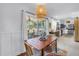 Dining room with view of kitchen and outdoor patio through screened in sliding glass doors at 11376 119Th Ter, Largo, FL 33778