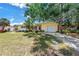Charming yellow single-story home featuring an attached one car garage and mature landscaping at 11376 119Th Ter, Largo, FL 33778