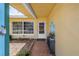 Cozy, covered front entry has a window, a decorative door, tiled patio, and colorful accents giving it curb appeal at 11376 119Th Ter, Largo, FL 33778