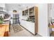 Bright kitchen with stainless steel refrigerator, glass front cabinets, and adjacent dining area at 11376 119Th Ter, Largo, FL 33778