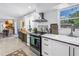 Open kitchen and dining area with stainless steel appliances and view to the colorful living space at 11376 119Th Ter, Largo, FL 33778