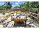 Cozy backyard patio setup with cushioned seating, perfect for outdoor relaxation and entertaining with a wooden fence surround at 11376 119Th Ter, Largo, FL 33778