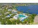 Aerial view of the community pool and clubhouse overlooking a serene lake at 11742 Lake Lucaya Dr, Riverview, FL 33579
