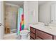 Bathroom with a walk-in shower, modern vanity, and framed mirror at 11742 Lake Lucaya Dr, Riverview, FL 33579