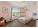 Charming bedroom featuring a window with natural light, and a four-poster bed at 11742 Lake Lucaya Dr, Riverview, FL 33579