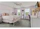 Bedroom with a four-poster bed, desk, and bright windows at 11742 Lake Lucaya Dr, Riverview, FL 33579