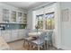 Bright breakfast nook featuring a round table, four chairs, and a large window overlooking the backyard at 11742 Lake Lucaya Dr, Riverview, FL 33579