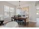 Elegant dining room with stylish chandelier, dark wood table, and unique wall art at 11742 Lake Lucaya Dr, Riverview, FL 33579