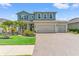 Charming two-story home with a three-car garage, manicured lawn, and inviting front porch at 11742 Lake Lucaya Dr, Riverview, FL 33579