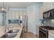 Well-equipped kitchen with stainless steel appliances, center island, and stylish lighting fixtures at 11742 Lake Lucaya Dr, Riverview, FL 33579