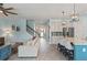 Open-concept living room showcasing seamless transition to kitchen, stainless steel appliances, and stairwell at 11742 Lake Lucaya Dr, Riverview, FL 33579