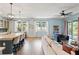 Open-concept living room with natural light, wood floors, modern furnishings, and access to the patio at 11742 Lake Lucaya Dr, Riverview, FL 33579