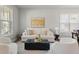 Bright living room with neutral decor, plush seating, and natural light from large windows at 11742 Lake Lucaya Dr, Riverview, FL 33579