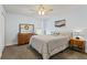 Comfortable main bedroom with stylish decor and wood furniture, illuminated by a ceiling fan at 11742 Lake Lucaya Dr, Riverview, FL 33579