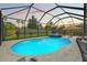 Screened-in pool and hot tub with ambient string lights and patio furniture at 11742 Lake Lucaya Dr, Riverview, FL 33579