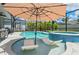 Relaxing screened-in pool area with in-pool loungers and a covered patio for outdoor dining at 11742 Lake Lucaya Dr, Riverview, FL 33579
