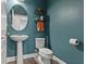Stylish powder room featuring a pedestal sink and elegant decor at 11742 Lake Lucaya Dr, Riverview, FL 33579