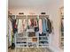 Walk-in closet with custom shelving and hanging racks at 11742 Lake Lucaya Dr, Riverview, FL 33579
