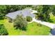 Beautiful single-story home with a well-manicured lawn and mature landscaping at 12435 Oak St, San Antonio, FL 33576