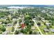 Aerial view of the property in a residential neighborhood close to a lake at 12435 Oak St, San Antonio, FL 33576