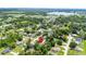 Aerial view of a home in a residential neighborhood, close to a lake at 12435 Oak St, San Antonio, FL 33576