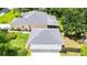 An elevated aerial view of a home with a three car garage and screened-in patio at 12435 Oak St, San Antonio, FL 33576