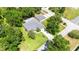 Aerial view of a home with well-defined property lines, mature trees, and lush green lawn at 12435 Oak St, San Antonio, FL 33576